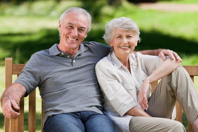 an older couple after receiving dental crowns and dental bridges