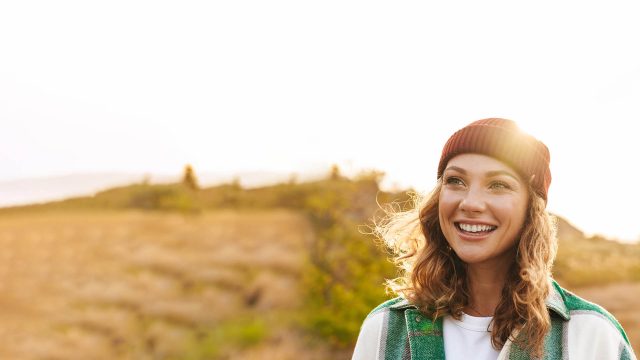 a young woman smiling out in the field
