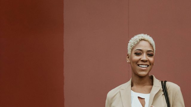 a woman smiling to show off her recently whitened teeth